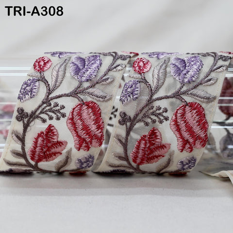 two rolls of fabric with a floral pattern, featuring red and purple flowers against a white background.