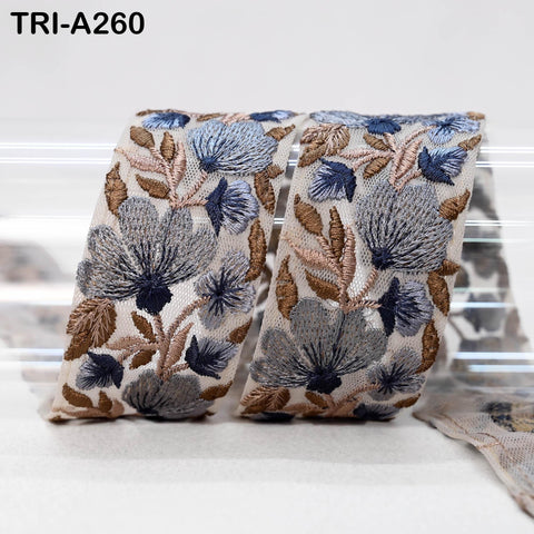 a decorative fabric with a floral pattern, including blue and brown flowers and leaves, arranged in a visually appealing manner.