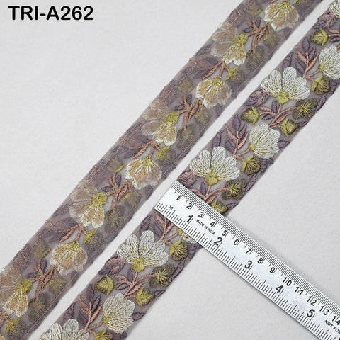 a close-up view of a decorative fabric with a floral pattern, featuring a ruler for scale.