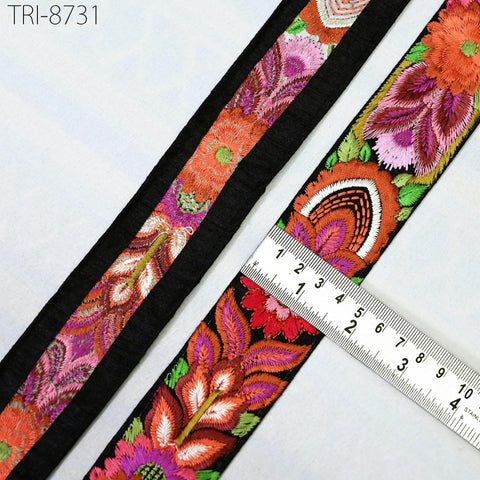 a close-up view of a decorative fabric with a floral pattern, featuring a ruler for scale.