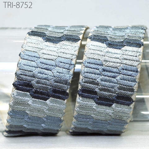 two pieces of fabric with a geometric pattern in shades of blue and gray.