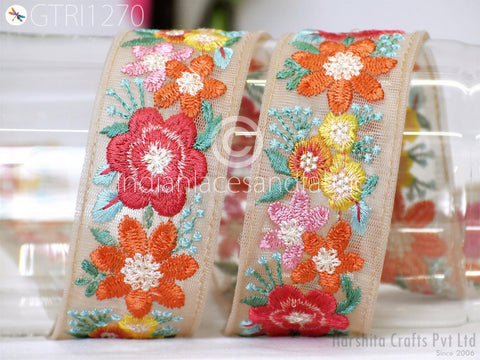 two decorative fabric pieces with vibrant floral embroidery. The pieces are placed side by side, showcasing the intricate patterns and colors of the embroidery.