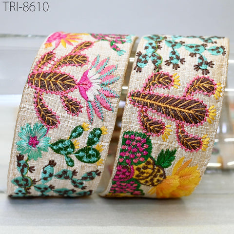 two decorative fabric pieces with intricate floral and leaf patterns in various colors, including pink, green, yellow, and brown.