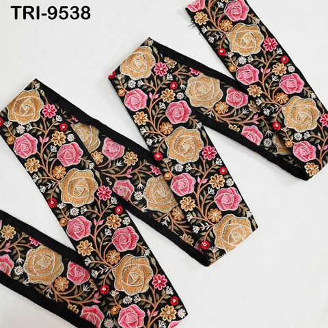 a collection of fabric pieces with a floral pattern in shades of pink, black, and gold. The pieces appear to be made of a material with a floral design, possibly a textile or fabric.