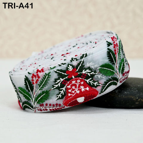 A decorative ribbon with a floral pattern in red, green, and white colors, featuring a bell-shaped design.
