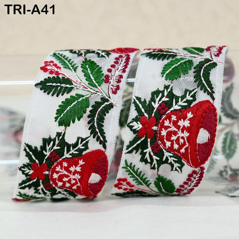 two pieces of fabric with a floral pattern, including red and green leaves, flowers, and a bell shape.
