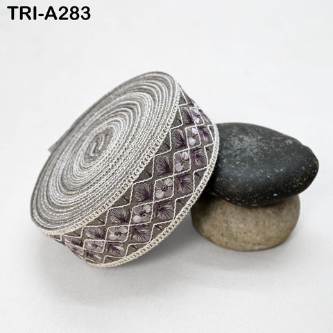 a decorative fabric with a floral pattern, placed on top of two rocks.