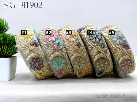 a collection of decorative headbands with intricate floral embroidery, arranged in a row on a table.