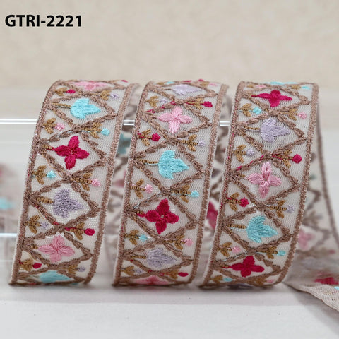 three decorative fabric pieces with intricate embroidered patterns in various colors, including pink, blue, and brown.
