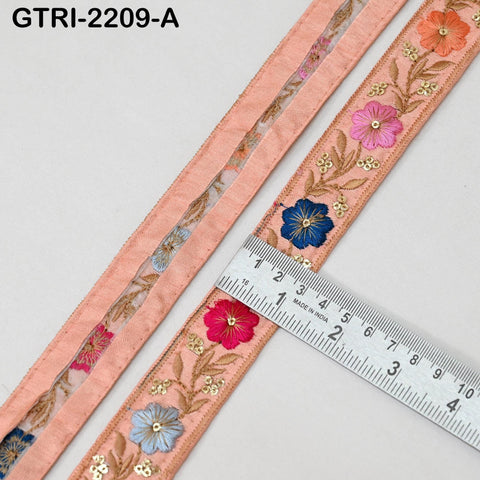 a close-up view of a decorative fabric with a floral pattern, featuring a ruler for scale.
