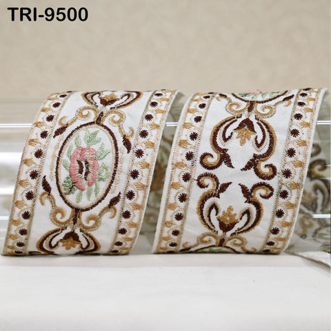 two decorative fabric pieces with intricate floral and ornamental patterns in shades of white, brown, and gold.