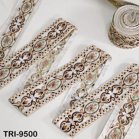 several rolls of decorative fabric with intricate floral and paisley patterns, arranged on a white background.