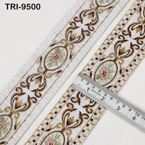 a close-up view of a decorative fabric with a floral pattern, featuring a ruler for scale.