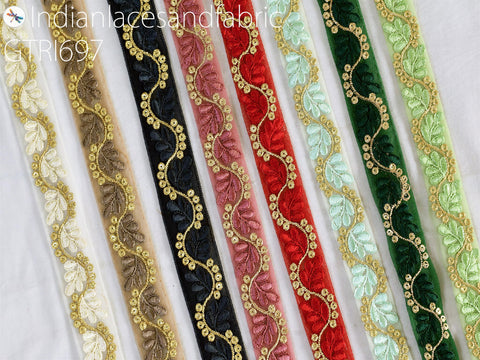 a collection of decorative fabric strips with intricate embroidered patterns in various colors, including gold, black, red, green, and white.