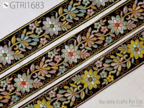 three decorative floral embroidered borders, each with a unique pattern of flowers and leaves in various colors such as green, pink, and yellow. The borders are arranged in a row, creating a visually appealing and intricate design.