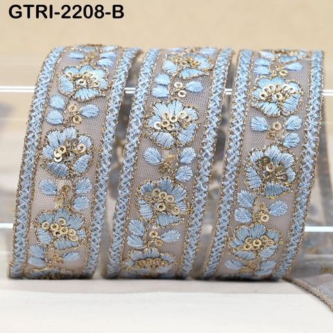a set of decorative fabric pieces with intricate floral patterns in shades of blue and gold. The pieces appear to be made of a light-colored material, possibly lace or fabric, and are arranged in a row.