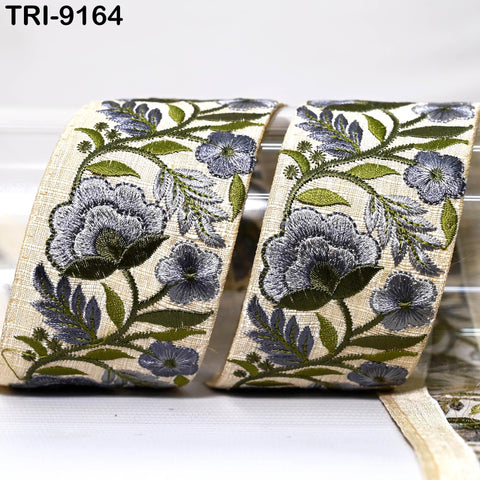 two rolls of fabric with a floral pattern, including blue and green flowers and leaves.