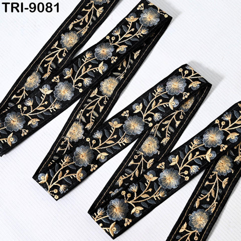 several black and gold embroidered fabric pieces arranged in a zigzag pattern on a white background.