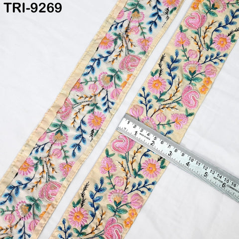 two pieces of fabric with a floral pattern, one with a beige background and the other with a white background. A ruler is placed between the two pieces of fabric, indicating the size of the fabric.