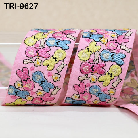 a pink ribbon with a playful, cartoon-like design of various colorful bunny characters.
