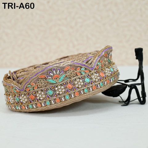 a decorative beaded border with intricate floral and geometric patterns, placed on a white surface.