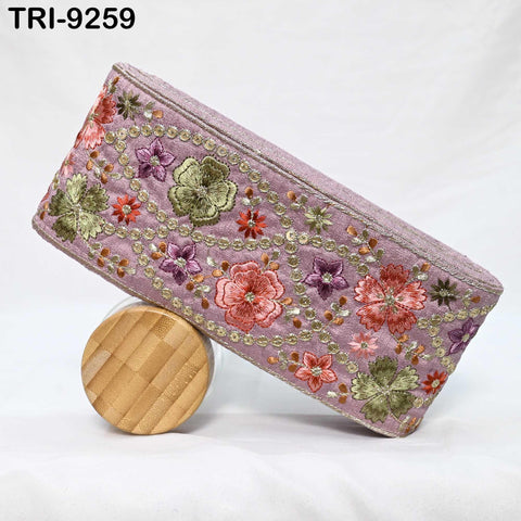 A handbag with a floral pattern and a wooden lid resting on it.