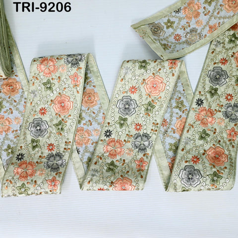 a collection of fabric pieces with floral patterns, including a large piece of fabric with a floral design and a smaller piece with a similar pattern. The fabric appears to be made of a light-colored material, possibly cotton or linen, and is displayed against a white background.