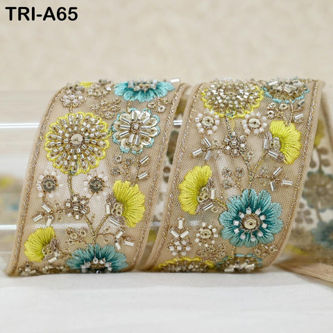 a decorative fabric with a floral pattern, including yellow and blue flowers, and intricate beading and embroidery work.