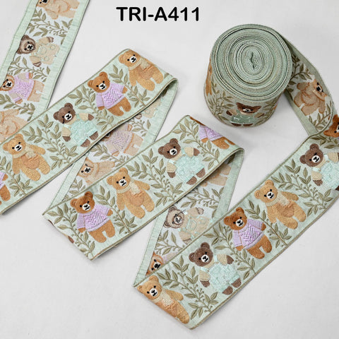 a collection of green and white fabric ribbons with a repeating pattern of teddy bears. The ribbons are arranged in a way that they appear to be rolled up or coiled together.