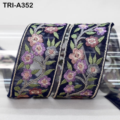 two decorative fabric pieces with a floral pattern, featuring a combination of purple, pink, and green flowers arranged in a repeating design.