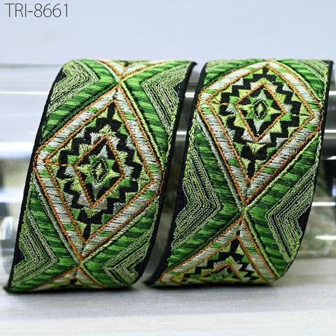 two decorative fabric pieces with intricate geometric patterns in shades of green, orange, and black.