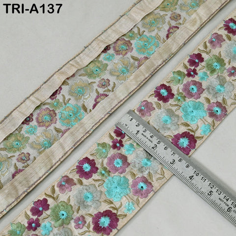 a close-up view of a decorative fabric with a floral pattern, featuring a ruler for scale.