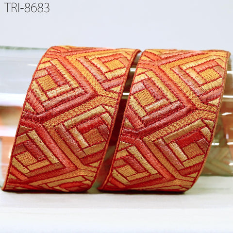 two pieces of red and gold embroidered fabric, with a geometric pattern.