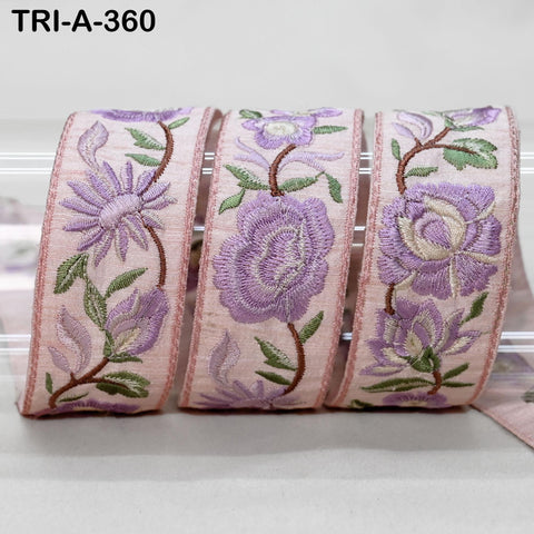 A set of three decorative fabric ribbons with floral patterns in shades of pink and purple.