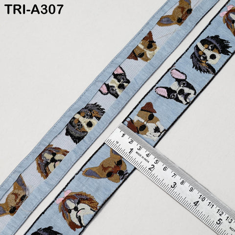 a blue fabric with a repeating pattern of dog faces, and a ruler is placed on top of the fabric to measure its length.