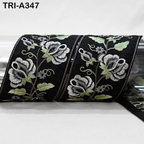 a close-up view of a black and white floral embroidered ribbon.