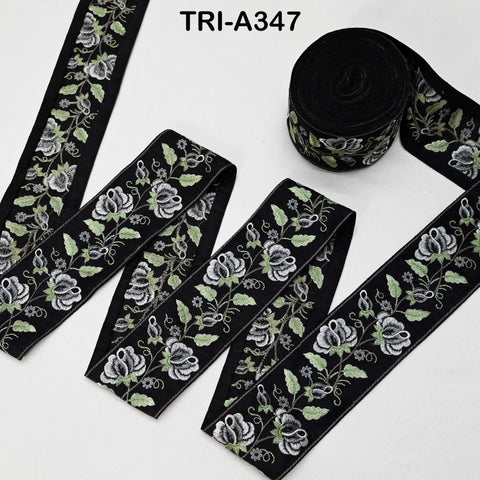 several spools of black and white floral embroidery thread, arranged on a white background.