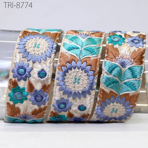 three decorative fabric pieces with intricate floral patterns in shades of blue, brown, and white.