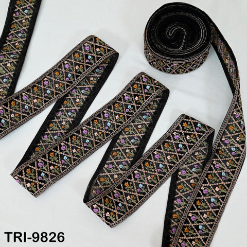 a collection of decorative fabric pieces, including a black and gold embroidered piece and a black and gold ribbon.