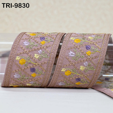 a decorative fabric with a floral pattern, featuring a repeating design of yellow and purple flowers. The fabric appears to be a decorative trim or border, possibly used for embellishing clothing or other textile items.