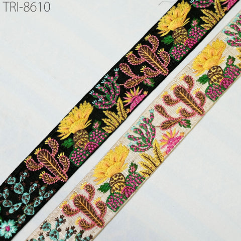 two spools of embroidered fabric with colorful floral designs.