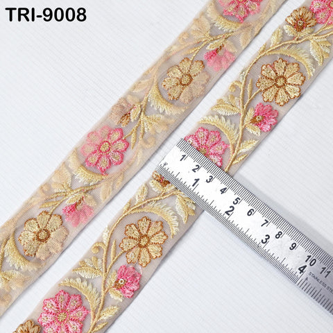 a decorative fabric with a floral pattern, featuring a ruler placed on top of it to measure the length.