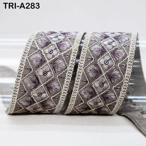 a decorative fabric with a repeating pattern of purple and white flowers, creating a visually appealing and intricate design.