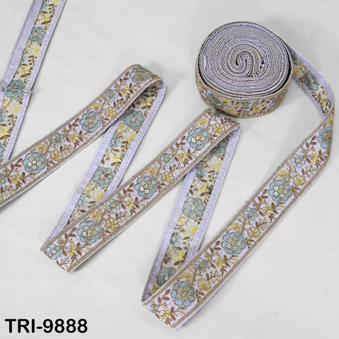 a collection of decorative fabric pieces, including a large roll of fabric with a floral pattern and several smaller pieces of fabric with similar floral designs.