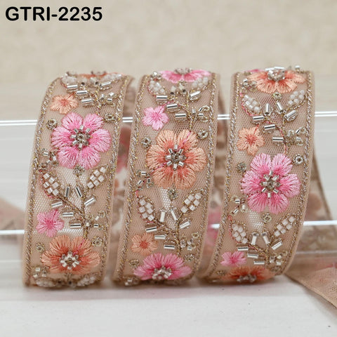 three decorative fabric pieces with intricate floral embroidery and beading details.