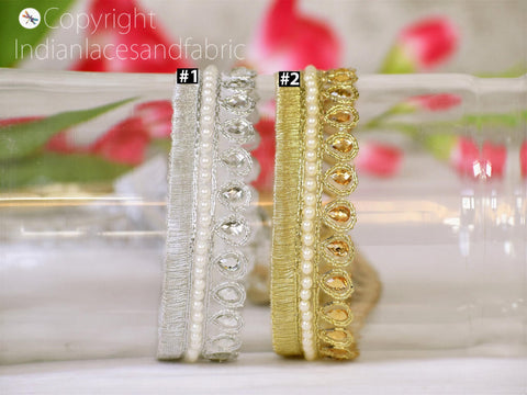 two decorative trims, one silver and one gold, placed side by side on a white surface.