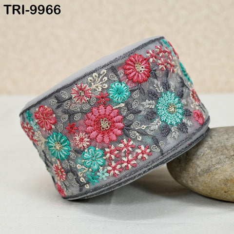 a gray fabric with a floral pattern, including red, green, and blue flowers, and a gray fabric with a floral pattern. The floral patterns are arranged in a circular fashion on the gray fabric.