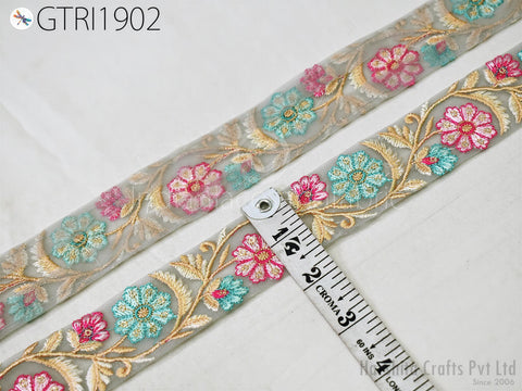 a decorative fabric with a floral pattern, featuring a ruler for size reference.