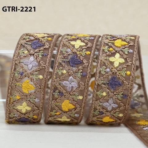three pieces of brown fabric with intricate floral embroidery in shades of yellow, purple, and green.