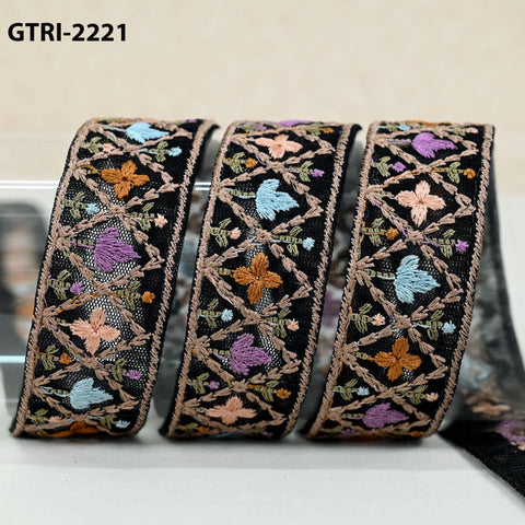 three decorative fabric pieces with intricate embroidered patterns in various colors, including black, blue, and orange.